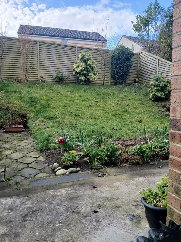 Homeowner turns steep hill into beautiful garden with free materials